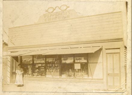 "Pepperell's Emporium", Main Road, Belfast, where today is an antique dealer.  Florrie Pepperell is at the door (date unknown) 91-158.jpg